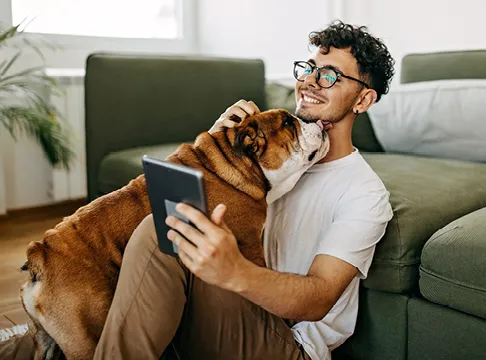 man on tablet with his dog