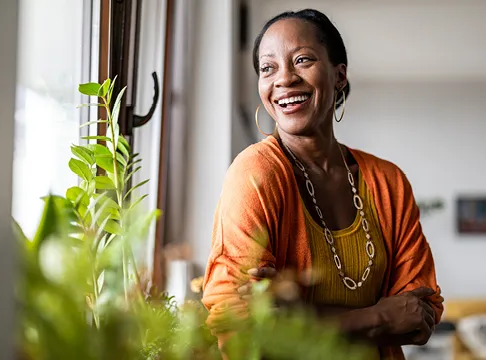 woman looking happy near a window
