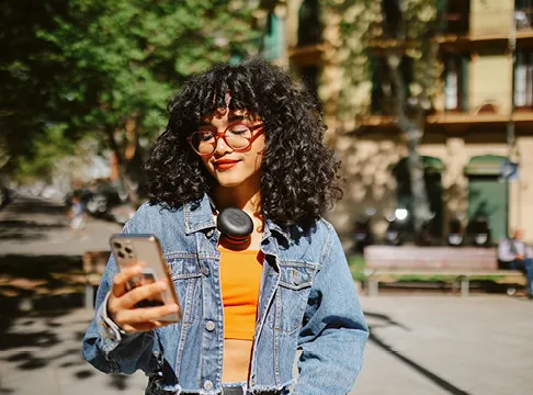 teen walking to class on phone