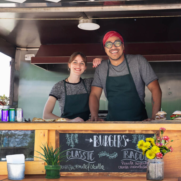 People smiling at a food stand image