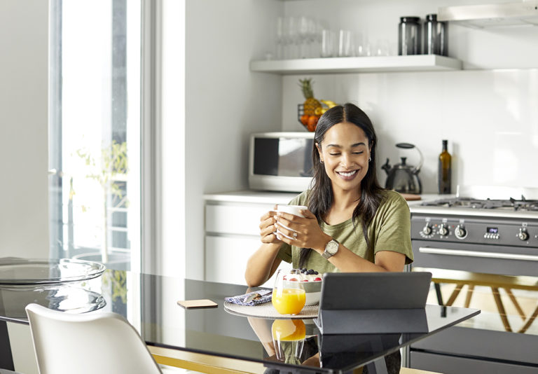 Woman on digital tablet at home image