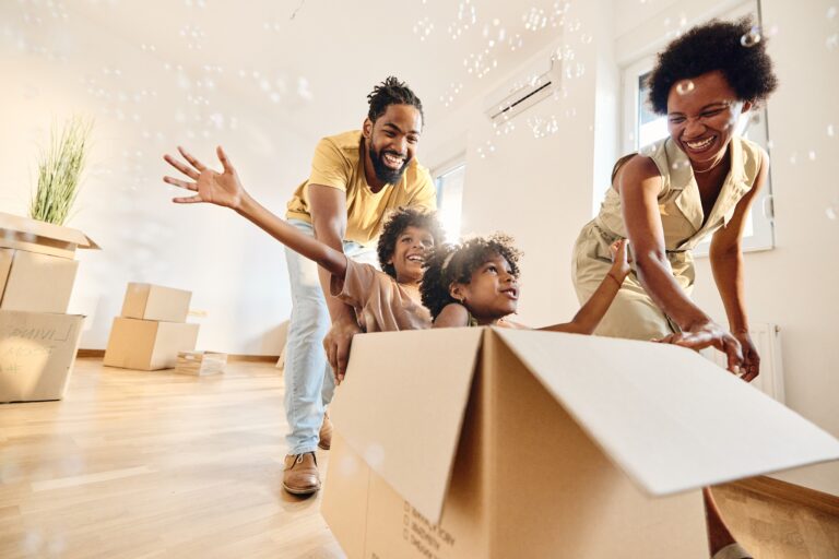 Carefree family having fun after moving into a new home image