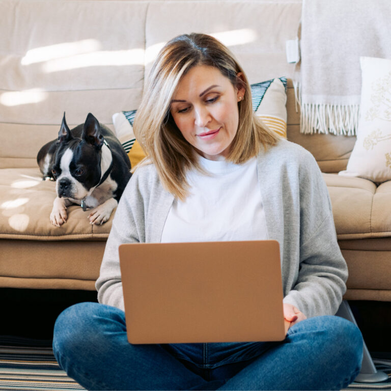 woman working from home with a boston terrier dog.