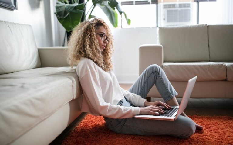 Young woman pictured online shopping using her laptop.