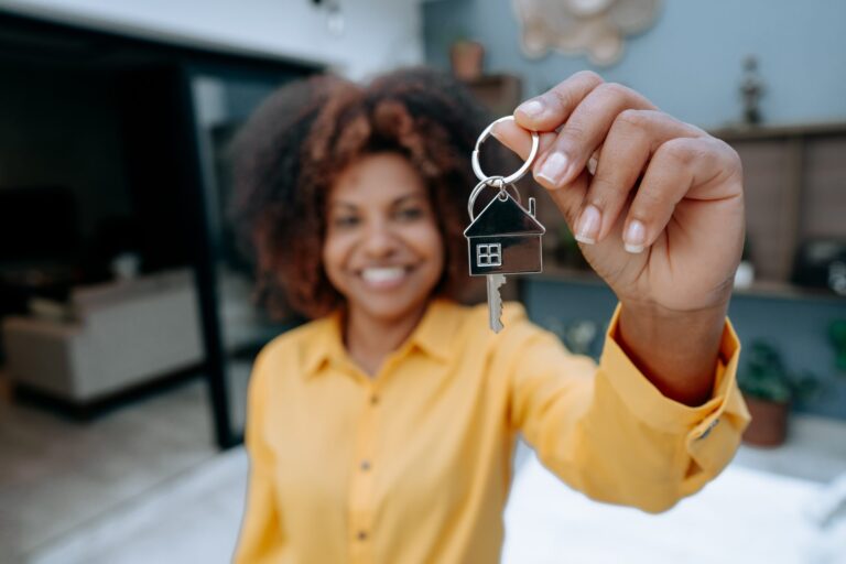 Woman holding keys to new house
