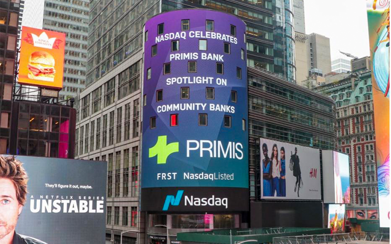 The Primis logo and stock ticker 'FRST' are showcased on Nasdaq's Times Square billboard.