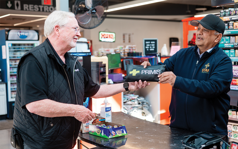 Primis V1BE driver delivering business banking materials to a convenience store owner in Virginia